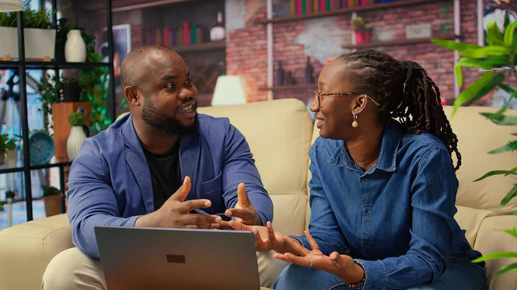 Two Nigerian professionals discussing a business project